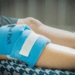 heat packs applied to knee to reduce pain