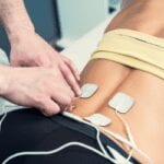 tens therapy applied to back for pain treatment